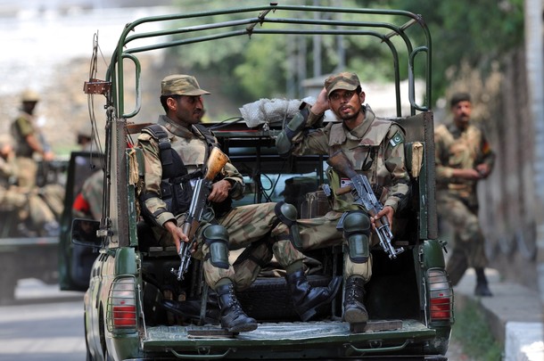 Pakistani army soldiers sit in the back