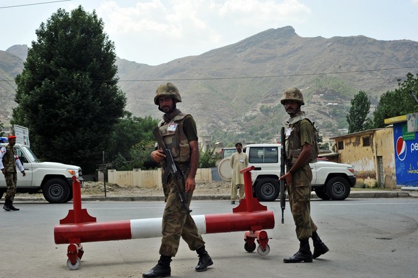 Pakistani army soldiers stand guard on a