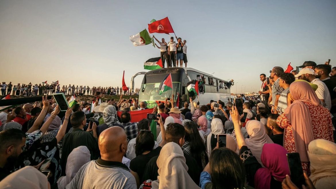 Tunisia-caravan-gaza Thousands of protesters wave Palestinian and national flags during the Gaza Global March, standing united atop and around a bus in Tunisia.