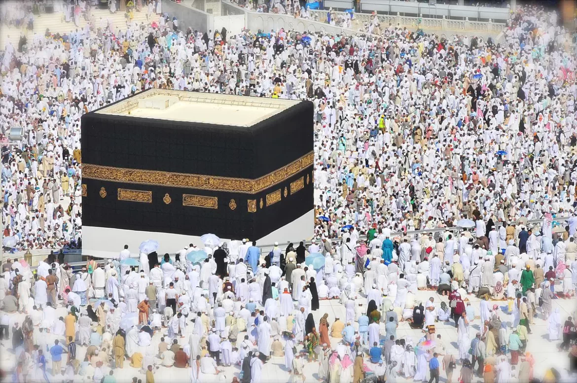 Aerial view of thousands of pilgrims in white attire surrounding the Kaaba, the sacred cubic building in Mecca, during Hajj.