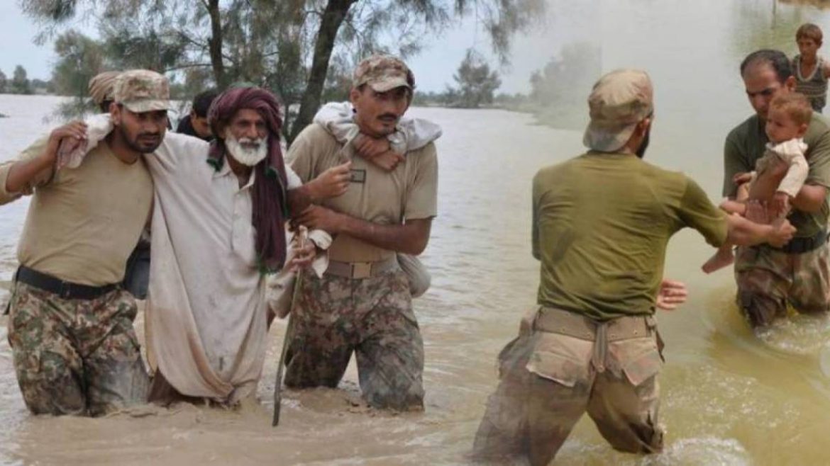 Flood rescue operation with soldiers aiding individuals wading through murky water, showcasing bravery and compassion amid a crisis.