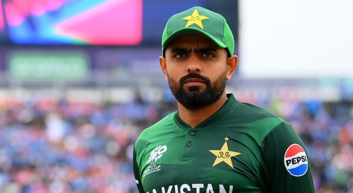 Pakistan cricket player Babar Azam in a green Pakistan team jersey stands against a blurred stadium background, with vibrant colors and fans visible.