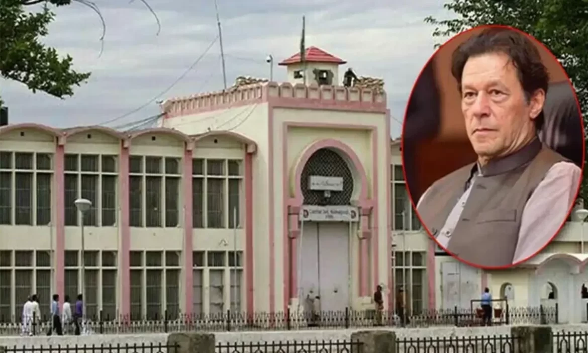 A pink and white building with large windows, surrounded by trees, witnesses a few people walking by under a cloudy sky.
