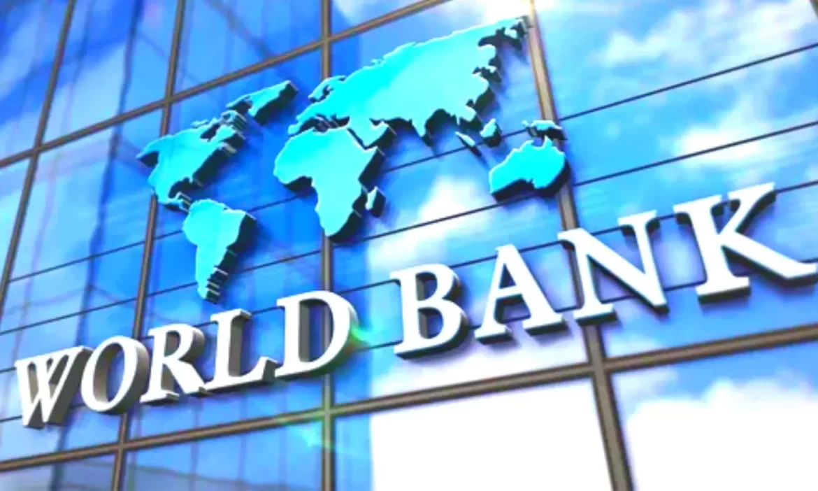 The image shows the World Bank logo, with the text "WORLD BANK" and a blue world map design on a reflective glass building surface.