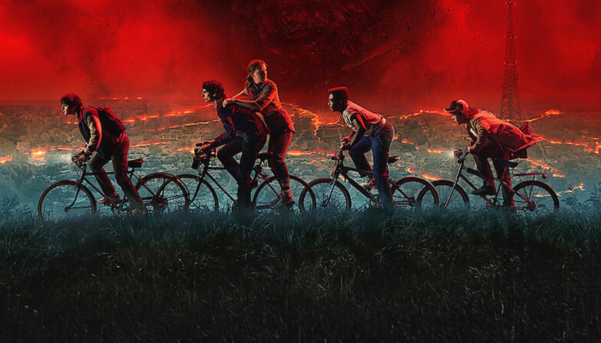 Stranger Things 5 promotional image featuring the main characters riding bikes through a fiery, post-apocalyptic landscape with a red sky in the background.