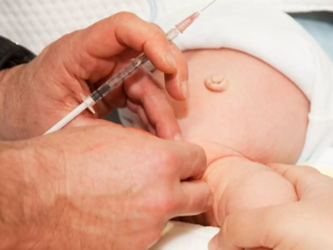 A healthcare professional administering a vaccination to a newborn's arm, showcasing gentle care and medical procedure.