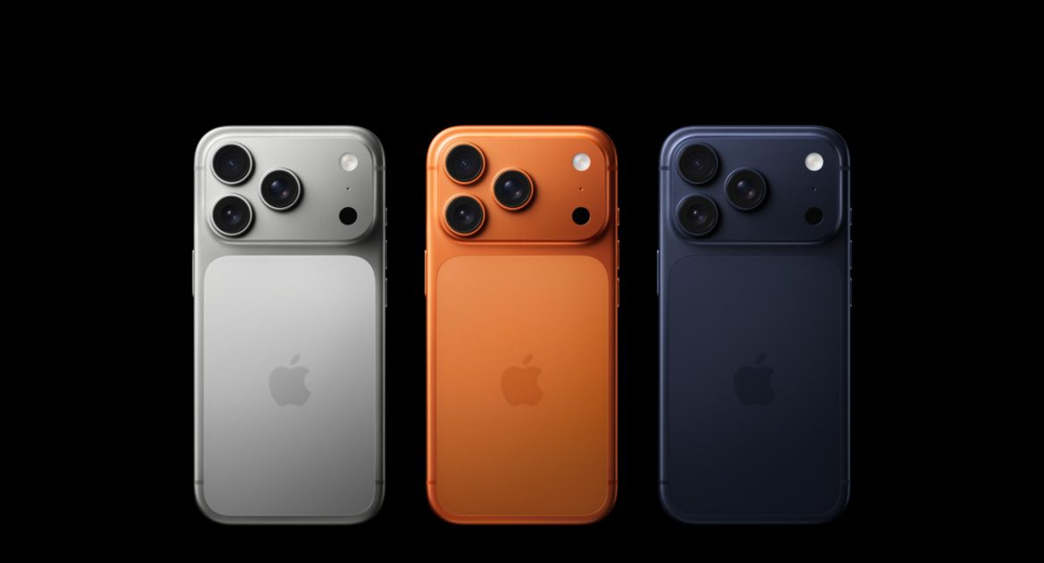 Three Apple smartphones in silver, orange, and navy blue, displaying their distinctive triple-camera setups against a black background.