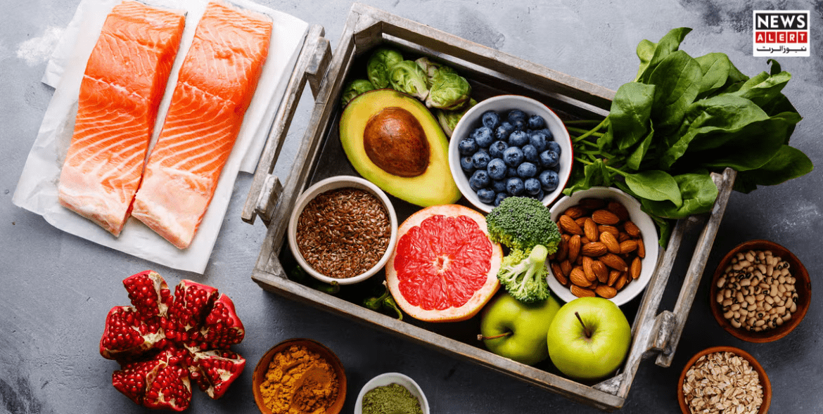 A variety of foods to lower blood pressure, including fresh salmon, avocado, blueberries, spinach, broccoli, pomegranate, almonds, flax seeds, apples, and turmeric, arranged in a basket for a healthy diet.