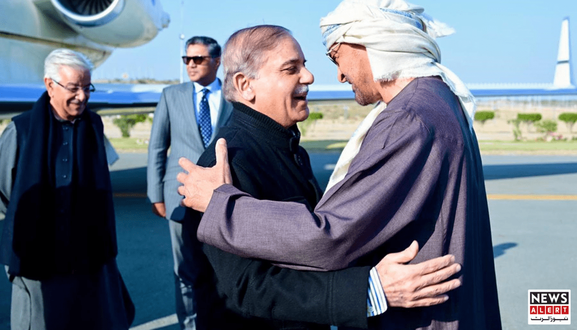 Two men embrace warmly on an airport tarmac, with another man and jet in the background, suggesting a moment of greeting or farewell.
