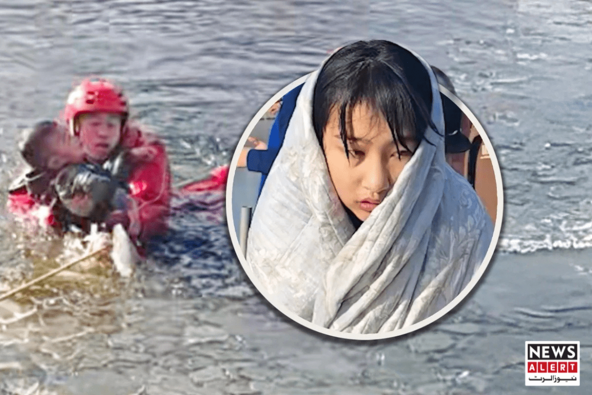 A rescue worker in a red suit supports a child in a shallow water, highlighting an urgent rescue situation.