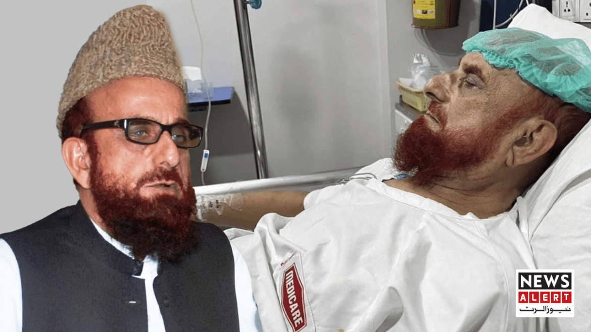 A person in a hospital bed wearing a white medical gown, with a medical monitor and equipment visible in the background.