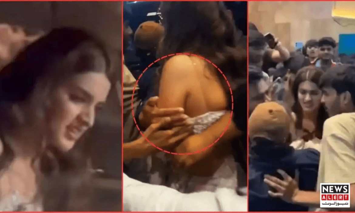 A crowded scene with multiple people, highlighting a hand reaching towards a shoulder in a busy environment.