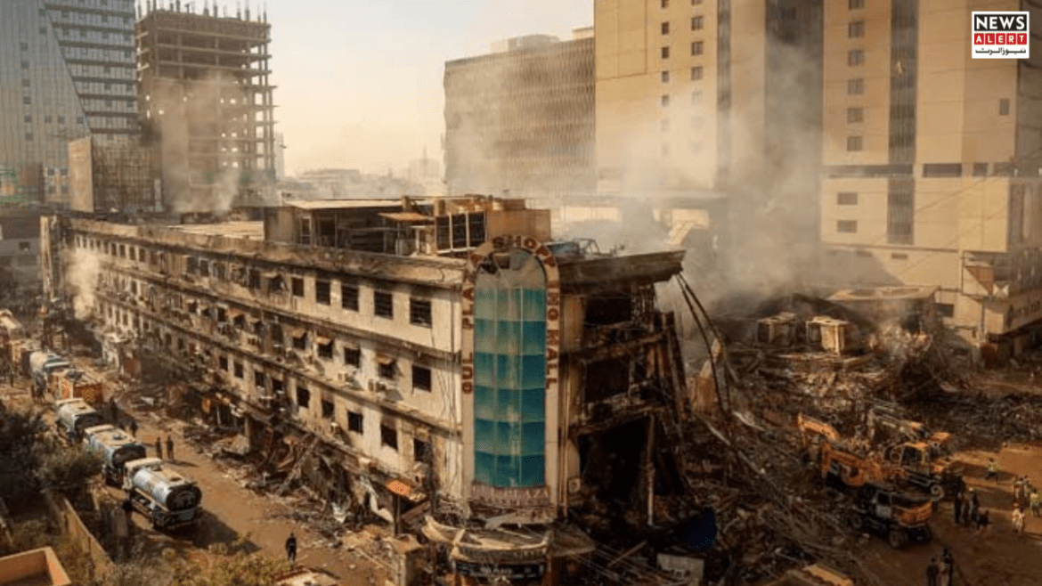 Devastating scene of a collapsed building with smoke rising, emergency vehicles and responders on-site in a city environment.